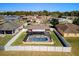 Aerial view of a screened in pool with a white fence and houses in the background at 3137 Winchester Estates Loop, Lakeland, FL 33810