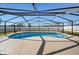 An inviting backyard oasis features a pool surrounded by a screened enclosure and fence at 3137 Winchester Estates Loop, Lakeland, FL 33810