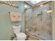 Bathroom featuring a glass enclosed shower with bench, tile surround, and a skylight at 3173 Sand Trap Ct, Lakeland, FL 33810