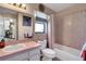 Bathroom with a sink, toilet, bathtub and shower combination, and window at 3173 Sand Trap Ct, Lakeland, FL 33810