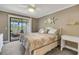 Comfortable bedroom with a ceiling fan and a sliding glass door to the lanai at 3173 Sand Trap Ct, Lakeland, FL 33810