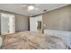 Bedroom features neutral colors, carpet, and access to the ensuite bathroom at 3173 Sand Trap Ct, Lakeland, FL 33810
