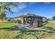 Charming home exterior with screened in porch, lush lawn, and landscaped walkway at 3173 Sand Trap Ct, Lakeland, FL 33810