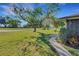 Lush front yard featuring mature trees and landscaped walkway at 3173 Sand Trap Ct, Lakeland, FL 33810