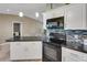 Updated kitchen features white cabinetry, tile backsplash, and black appliances at 3173 Sand Trap Ct, Lakeland, FL 33810