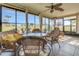 Bright sunroom with large windows, tile floors, and comfortable wicker furniture at 3173 Sand Trap Ct, Lakeland, FL 33810