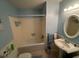 Bright bathroom with an oval mirror, blue walls and a bath tub at 330 W Wellington Dr, Lakeland, FL 33813