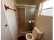 Compact bathroom includes a step-in shower, toilet, and small window at 330 W Wellington Dr, Lakeland, FL 33813