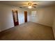Cozy bedroom with a ceiling fan, neutral carpet, and two door closets at 330 W Wellington Dr, Lakeland, FL 33813