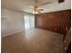 Classic living area with wood-look flooring, paneling and a ceiling fan at 330 W Wellington Dr, Lakeland, FL 33813
