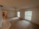 Bright living room is carpeted and has multiple windows to allow natural light at 330 W Wellington Dr, Lakeland, FL 33813