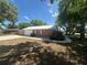 Side view shows the detached garage, manicured lawn, and convenient sidewalk around this home at 330 W Wellington Dr, Lakeland, FL 33813