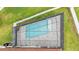 Aerial view of a backyard pool featuring a screened-in enclosure and manicured lawn at 3919 Vista Trace Way, Lakeland, FL 33810