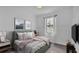 Bedroom with serene natural light from the window, soft colors and modern art at 3919 Vista Trace Way, Lakeland, FL 33810