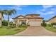 Charming single-Gathering home featuring a brick driveway, tile roof, and well-maintained landscaping at 3919 Vista Trace Way, Lakeland, FL 33810