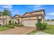 Charming two-story home with a tile roof, two-car garage, and beautifully landscaped front yard at 3919 Vista Trace Way, Lakeland, FL 33810