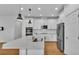 Modern kitchen with white cabinets, stainless steel appliances, and a large center island at 3919 Vista Trace Way, Lakeland, FL 33810
