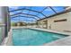 A screened-in pool with clean water is perfect for relaxing with views of the backyard at 3919 Vista Trace Way, Lakeland, FL 33810