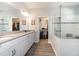 Bathroom featuring a large, white vanity with double sinks and a luxurious glass walk-in shower at 4189 Marseille Ln, Lakeland, FL 33810