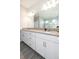Large bathroom with double vanity, modern lighting, and tile floors at 4189 Marseille Ln, Lakeland, FL 33810