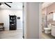 Hallway view into bathroom with a granite vanity and a glass enclosed shower at 4189 Marseille Ln, Lakeland, FL 33810