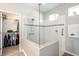 Modern bathroom featuring a glass walk-in shower and adjacent walk-in closet at 4189 Marseille Ln, Lakeland, FL 33810