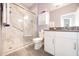Bathroom features granite vanity, white cabinets, and tiled shower with glass door at 4189 Marseille Ln, Lakeland, FL 33810