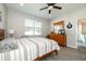 Bedroom with wood floors, neutral walls, and large windows, completed with a ceiling fan at 4189 Marseille Ln, Lakeland, FL 33810