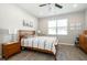 Comfortable bedroom featuring wood floors, neutral walls, and windows, complemented by a ceiling fan at 4189 Marseille Ln, Lakeland, FL 33810