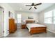 Bright bedroom featuring wood floors, neutral walls, and windows, complemented by a ceiling fan at 4189 Marseille Ln, Lakeland, FL 33810