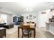Inviting dining area featuring a wooden table, modern lighting, and an open view to the living room at 4189 Marseille Ln, Lakeland, FL 33810