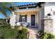 Inviting front porch with stone accents, comfortable seating, and a well-manicured garden at 4189 Marseille Ln, Lakeland, FL 33810