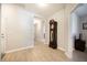Hallway featuring hardwood floors, neutral paint, and a grandfather clock at 4189 Marseille Ln, Lakeland, FL 33810