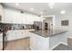 Bright kitchen featuring white cabinets, gray countertops, a tile backsplash, and stainless appliances at 4189 Marseille Ln, Lakeland, FL 33810