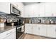 Charming kitchen with stainless steel appliances, modern cabinets, and decorative backsplash at 4189 Marseille Ln, Lakeland, FL 33810