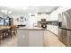 Modern kitchen featuring white cabinets, stainless steel appliances, gray countertops, and an open layout at 4189 Marseille Ln, Lakeland, FL 33810