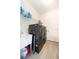 The laundry room has tile floors, modern machines, a utility sink and storage space at 4189 Marseille Ln, Lakeland, FL 33810