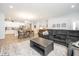 Open-concept kitchen and living room boasts stainless appliances, modern cabinets, and a large sectional at 4189 Marseille Ln, Lakeland, FL 33810