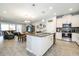 Bright, open-concept living area featuring a modern kitchen with stainless steel appliances and a living room at 4189 Marseille Ln, Lakeland, FL 33810