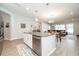 Spacious, open-concept living area featuring a kitchen with island and living room with large windows at 4189 Marseille Ln, Lakeland, FL 33810