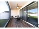 The screened patio has a table and chairs and overlooks the backyard at 4189 Marseille Ln, Lakeland, FL 33810