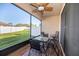 Relaxing screened patio with a ceiling fan and outdoor seating overlooks a grassy backyard at 4189 Marseille Ln, Lakeland, FL 33810