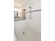 Bright shower featuring white tile, decorative accent tile and a convenient grab bar at 4189 Marseille Ln, Lakeland, FL 33810