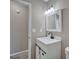 Bathroom with white vanity, decorative black fixtures and lighting, and wood-look tile flooring at 4228 Sunny Land Dr, Lakeland, FL 33813