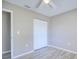 Neutral bedroom showcasing wood-look floors, a ceiling fan, and double-door closet at 4228 Sunny Land Dr, Lakeland, FL 33813