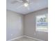 Cozy bedroom with wood-look floors, a ceiling fan, and a window with backyard views at 4228 Sunny Land Dr, Lakeland, FL 33813