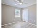 Neutral bedroom featuring wood-look floors, a ceiling fan, and a double-door closet at 4228 Sunny Land Dr, Lakeland, FL 33813