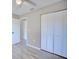 Bedroom with closet, light grey walls, wood-look flooring, doorway, and trim at 4228 Sunny Land Dr, Lakeland, FL 33813