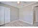 Neutral bedroom with closet, light grey walls, wood-look flooring, and doorway at 4228 Sunny Land Dr, Lakeland, FL 33813