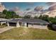 Charming single-story home with a gray exterior, updated roof, and an attached two-car garage at 4228 Sunny Land Dr, Lakeland, FL 33813